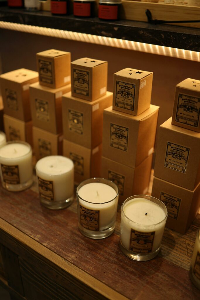 A cozy display of scented candles and boxes in a boutique shop setting.